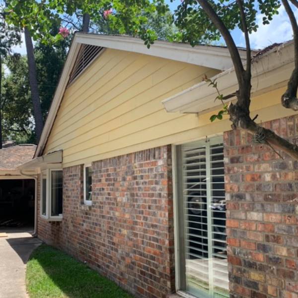 Brick and siding house with a window.