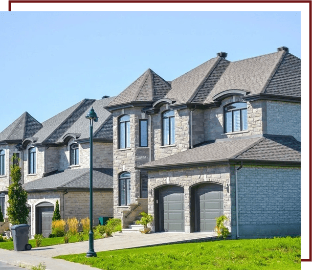 A row of houses with a green lawn in front.